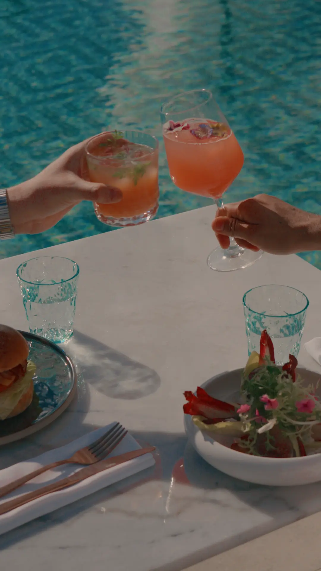 Cocktails by the pool at golden hour